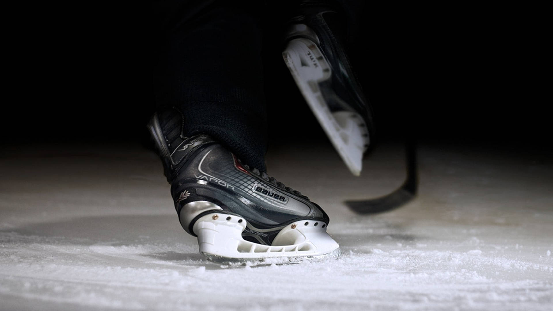 Fierce Ice Skating Blades Of A Hockey Player Background