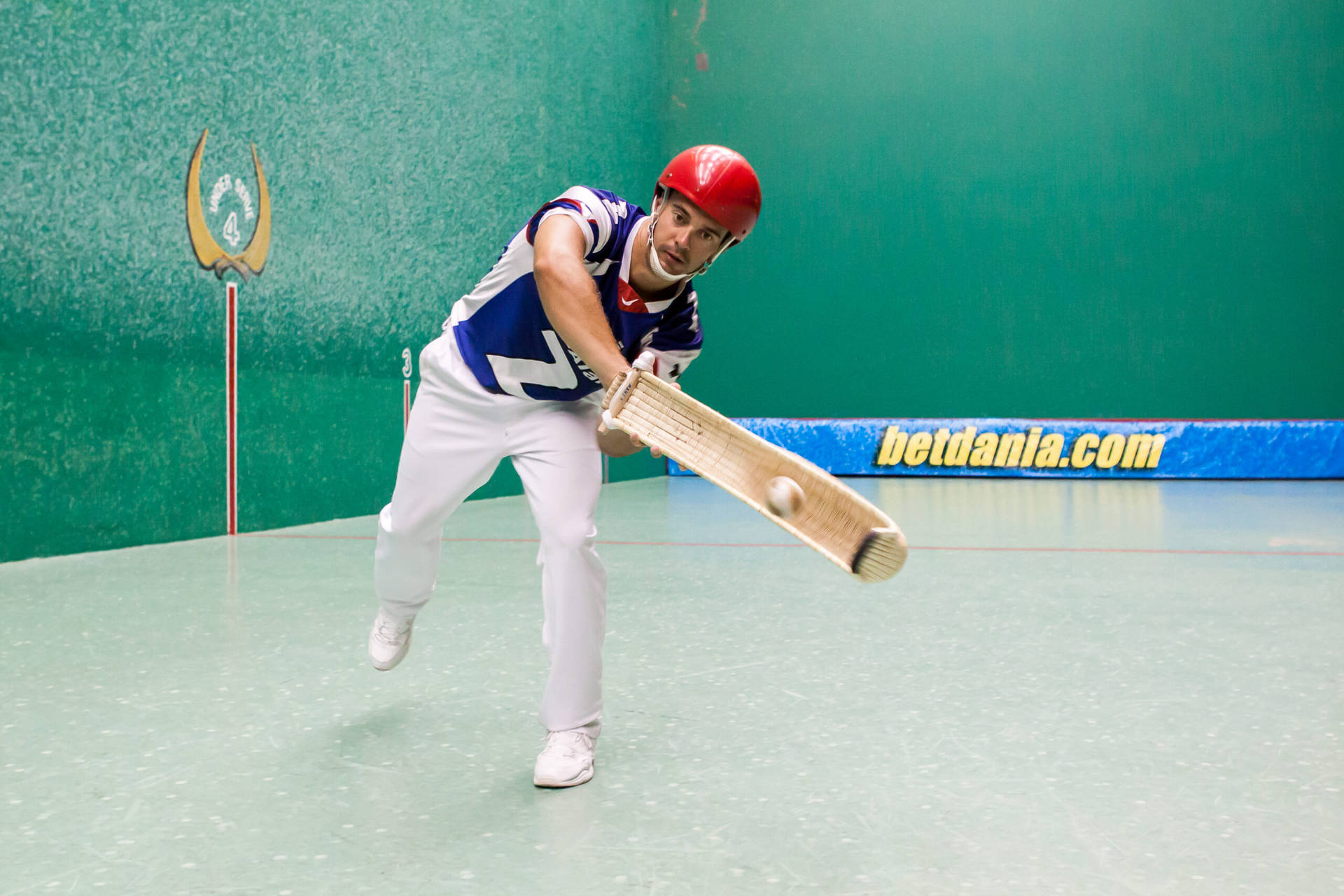 Fierce Jai Alai Player In Action Background