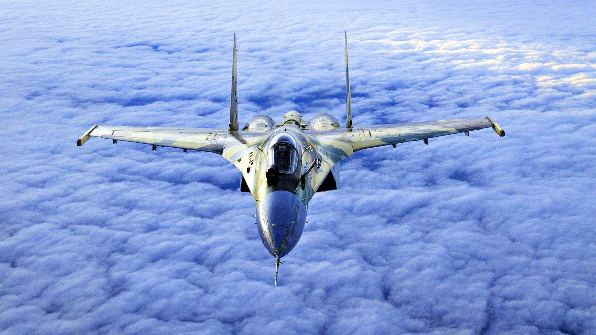 Fighter Jet Over A Cloud Cover Background