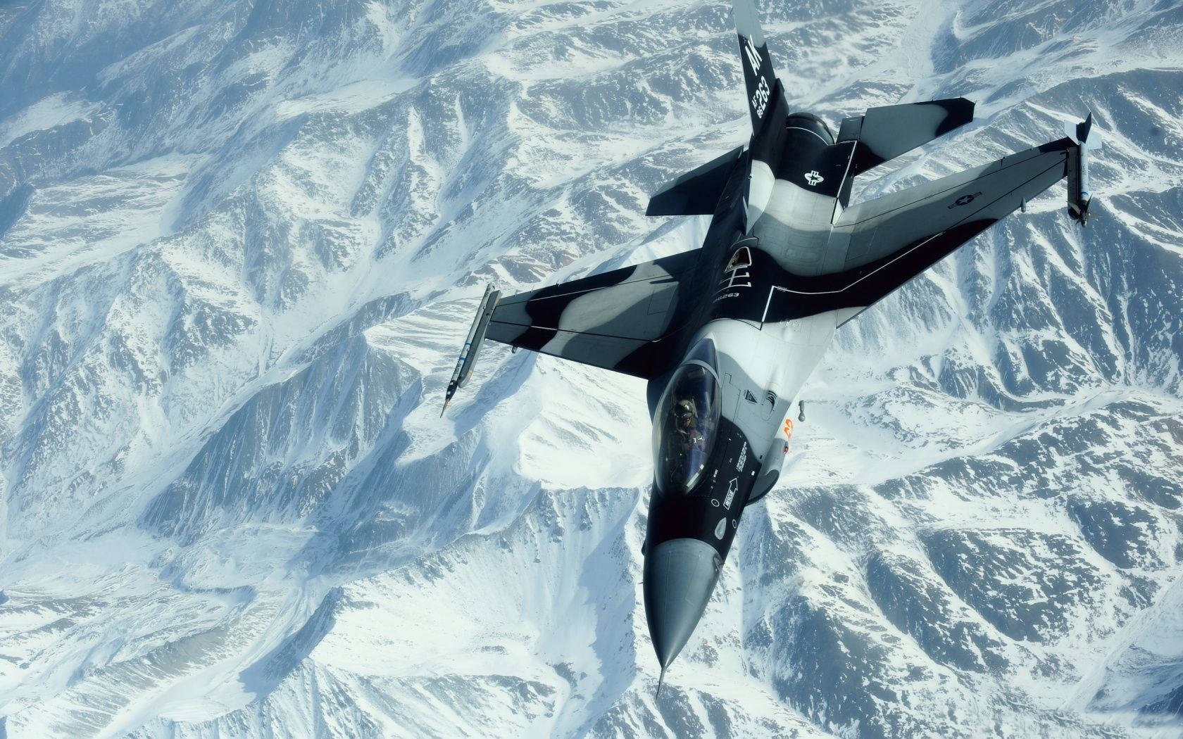 Fighter Jet Over The Snowy Mountains Background