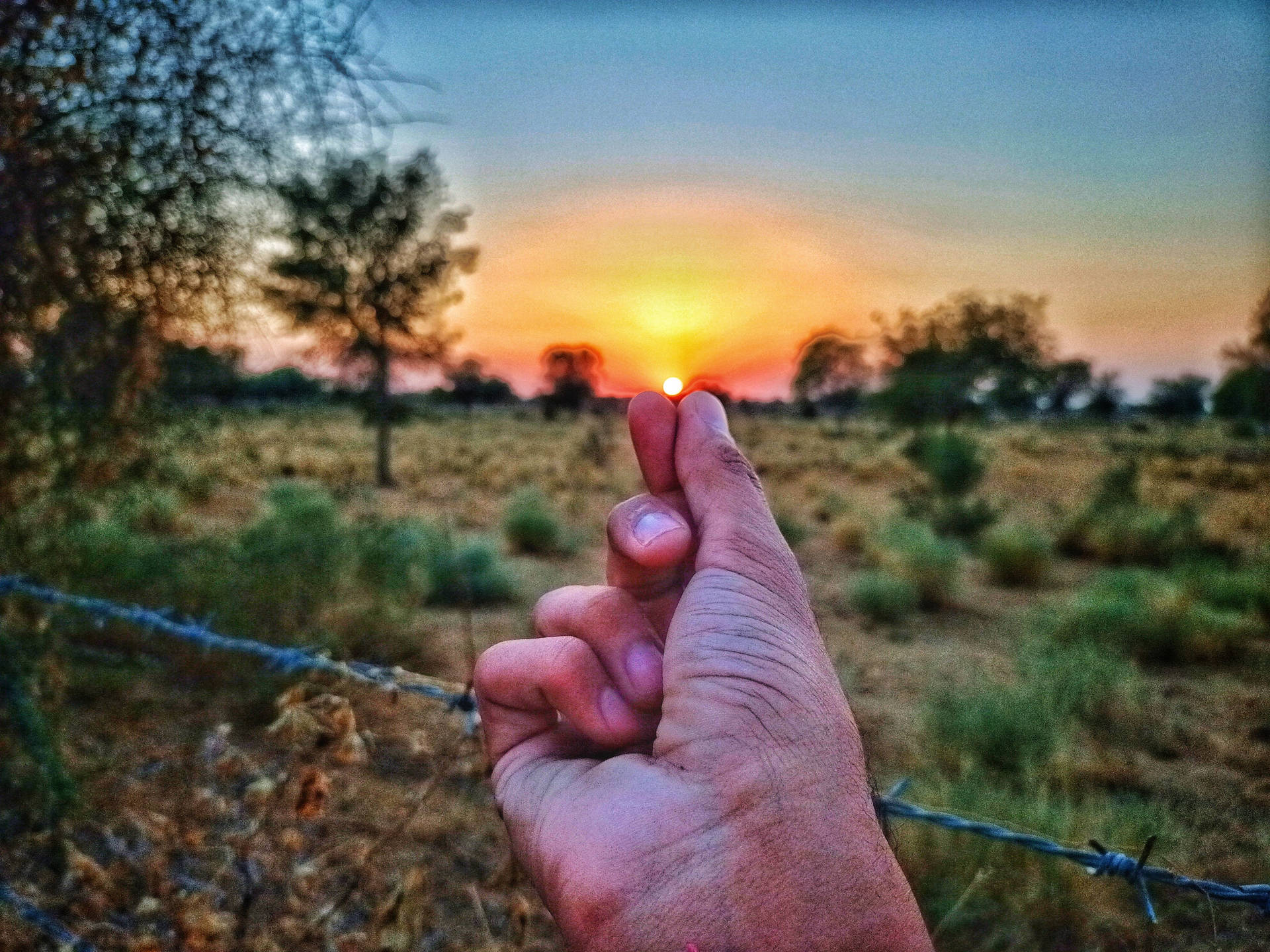 Finger Heart Pointing To A Sunset Background