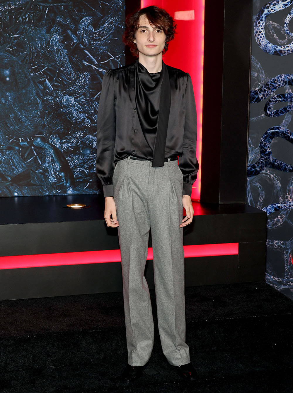 Finn Wolfhard With Gray Pants Background