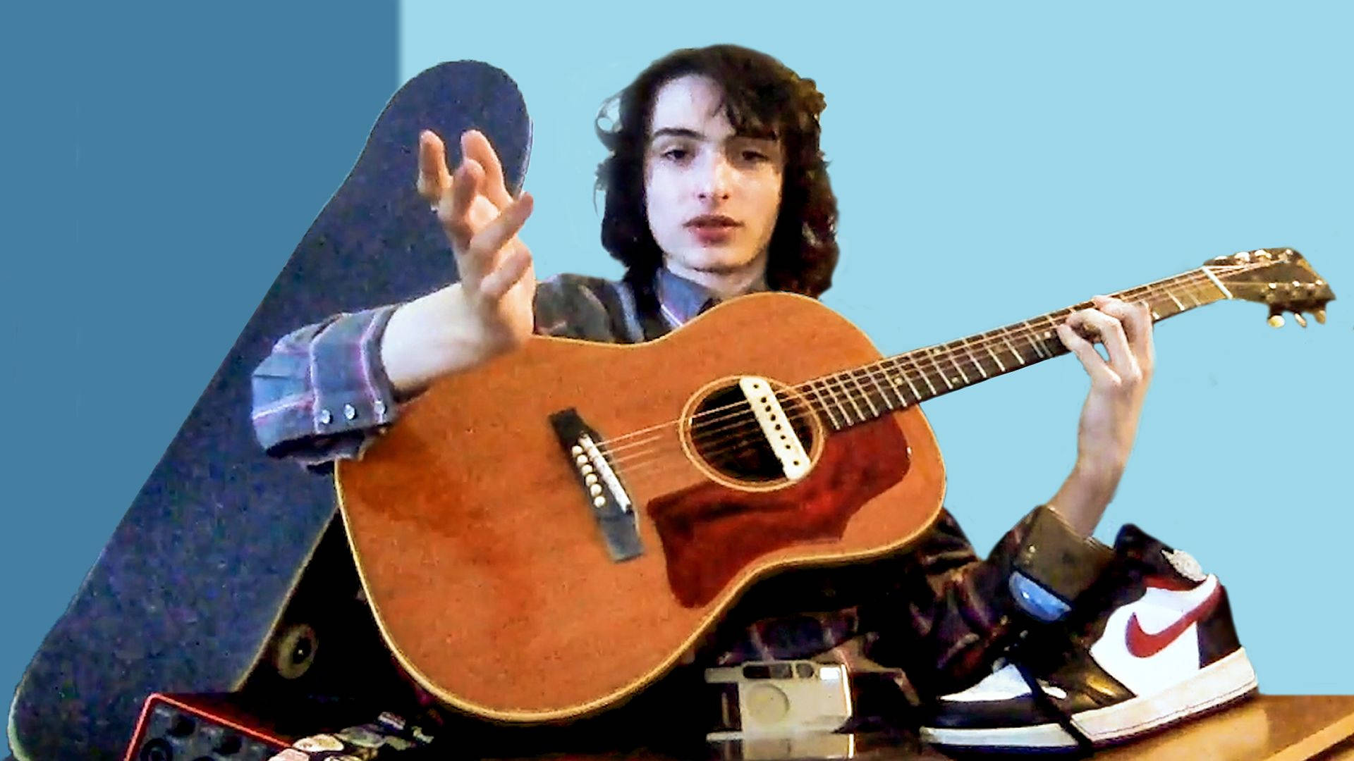 Finn Wolfhard With Guitar Background