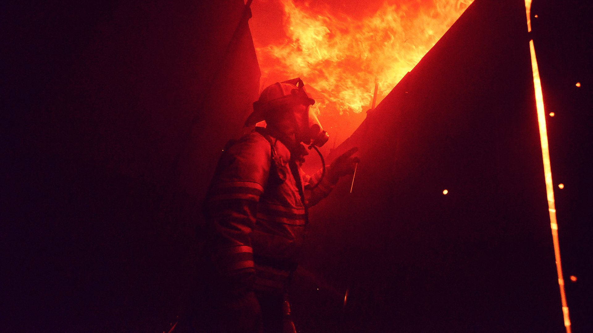 Firefighter In The Dark Fire Background