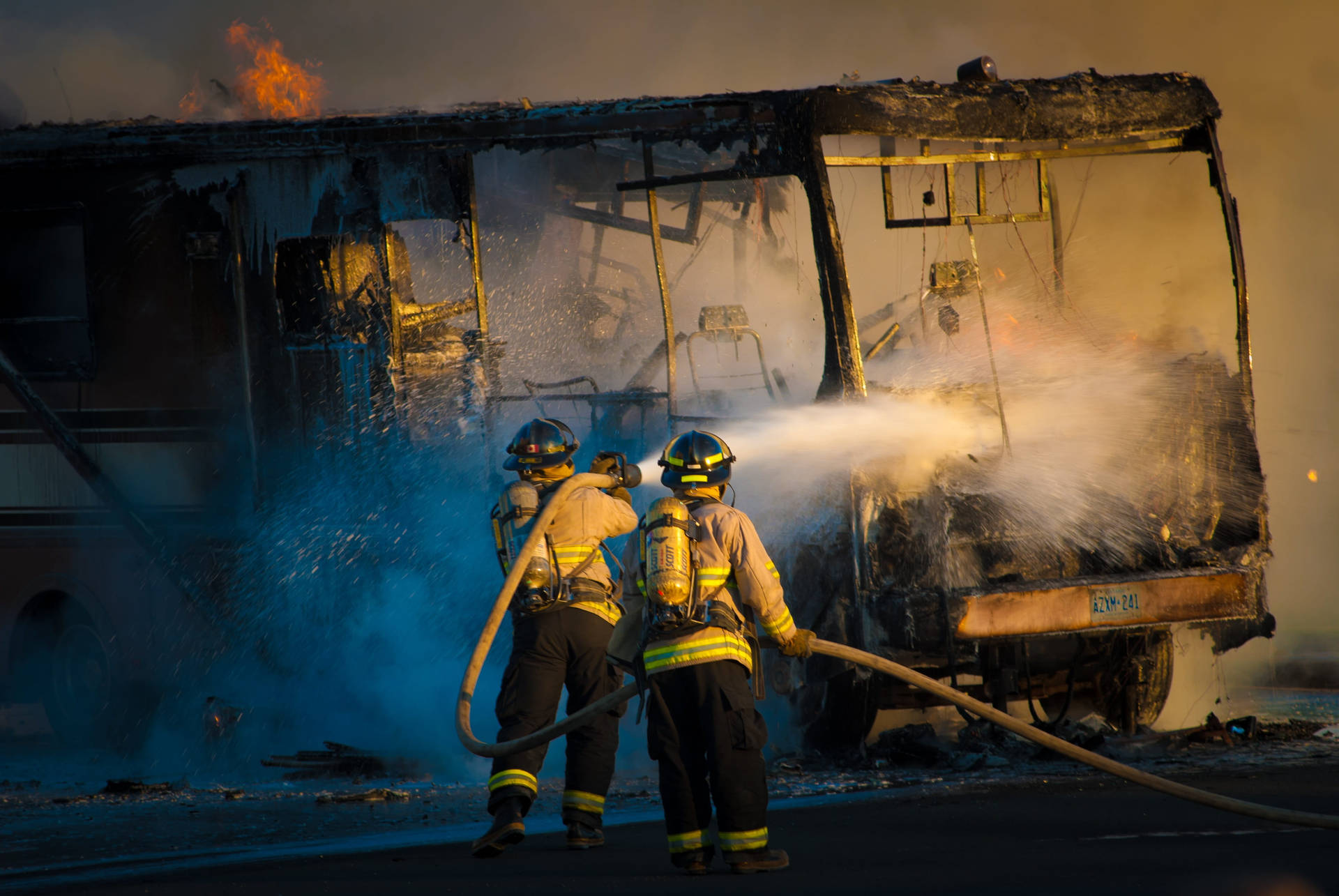 Firefighters Hosing Down A Bus