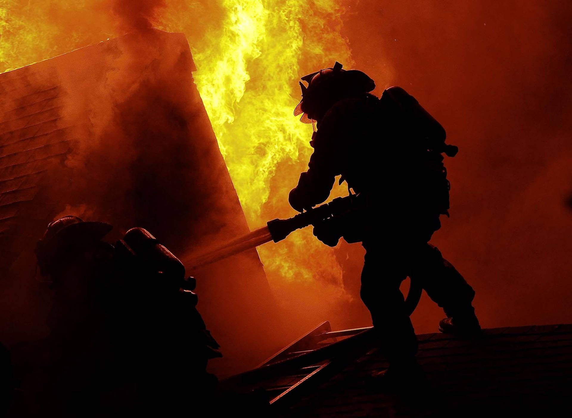 Firefighters On A Burning Roof Background