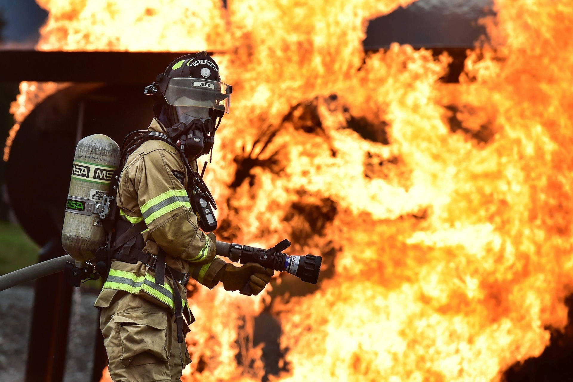 Firefighters On Duty With Hose Background