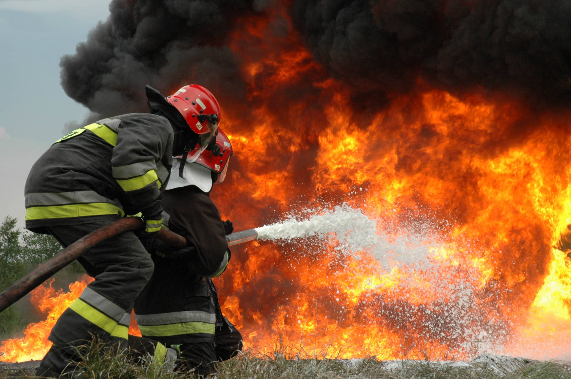 Fireman Fighting A Huge Fire Background