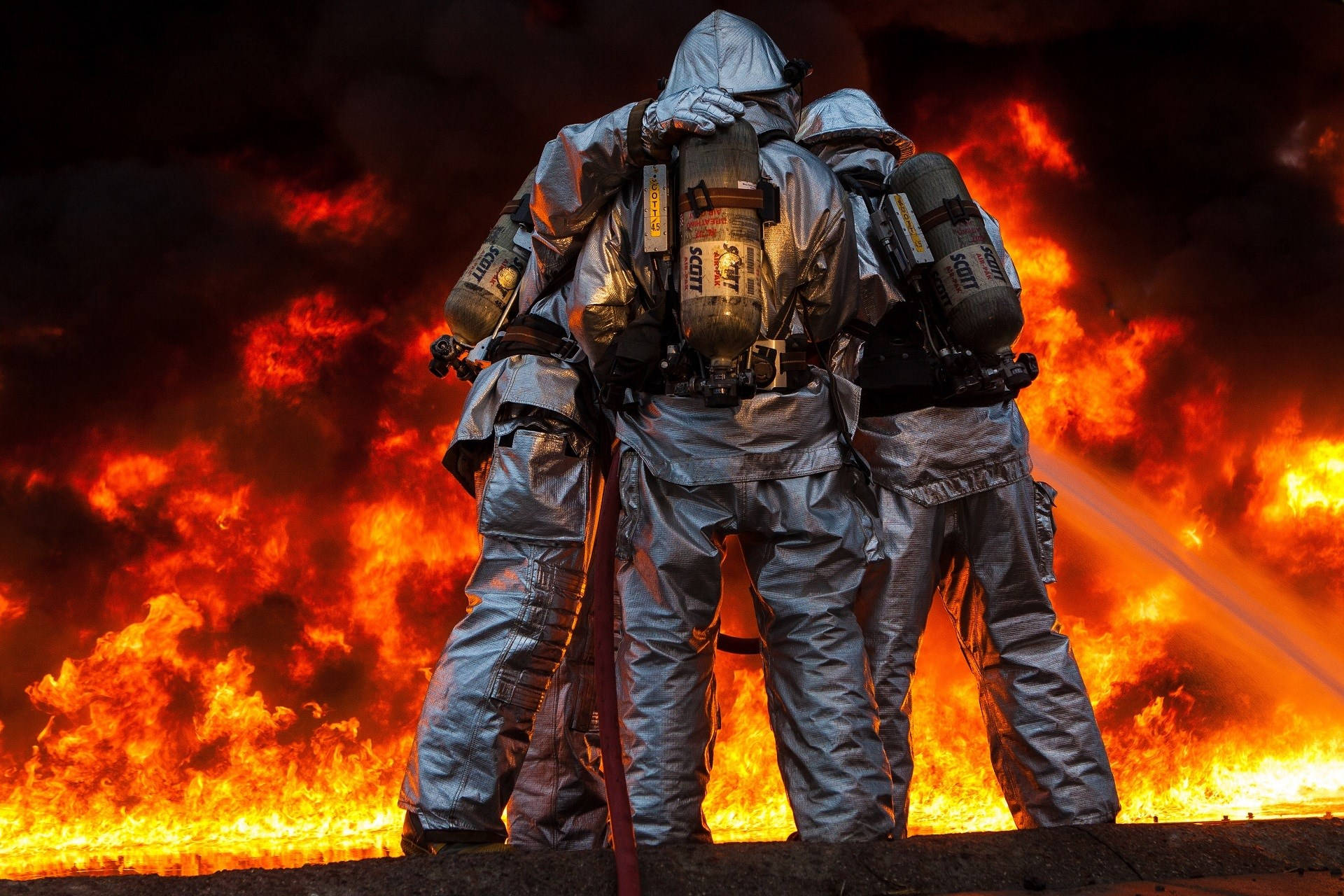 Fireman With His Team Against A Fire Background