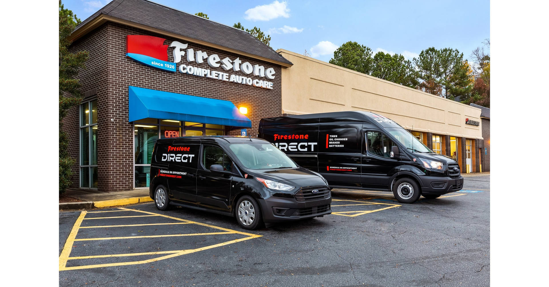 Firestone Shop With Cars On Parking Lot Background