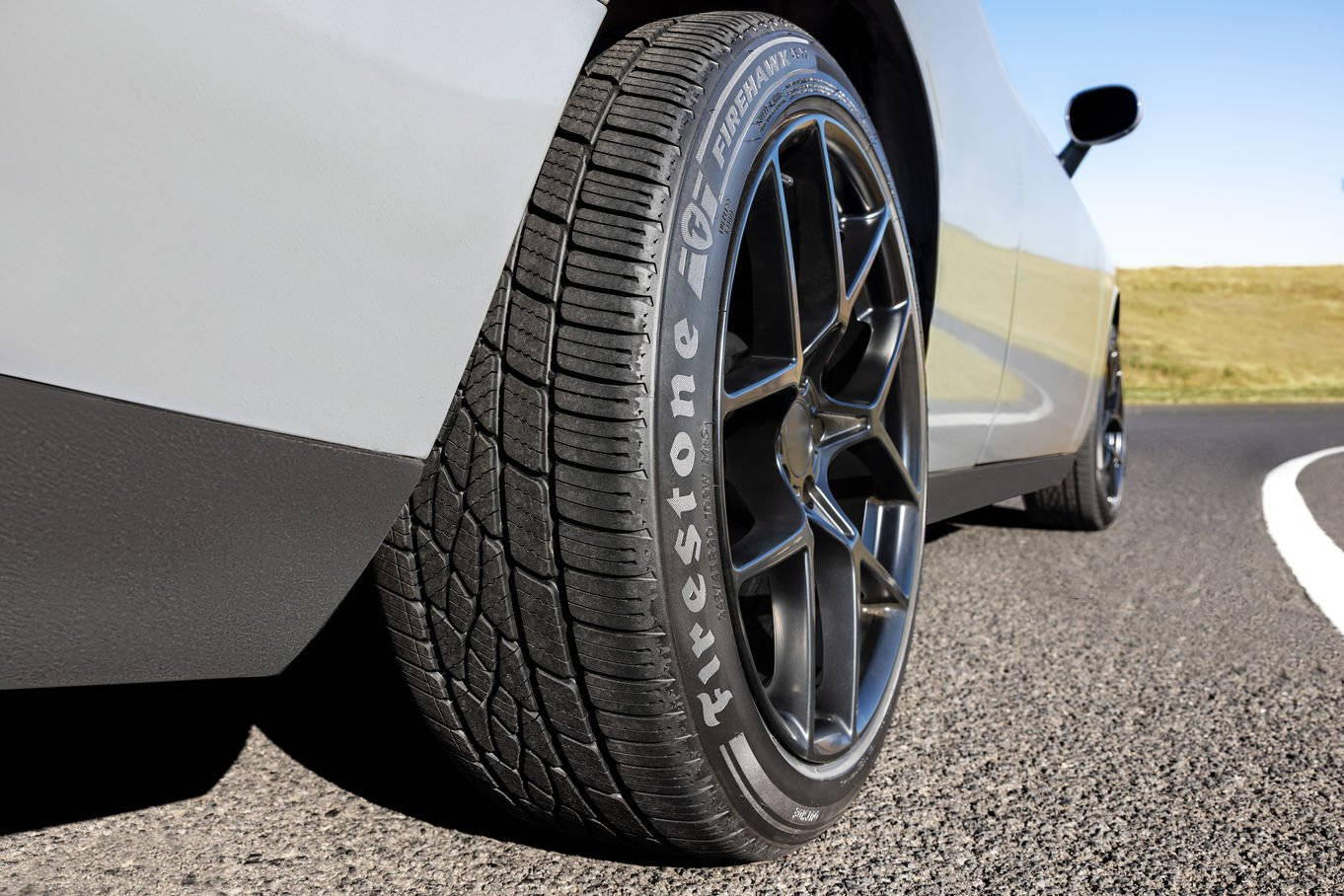 Firestone Tire On Car Background