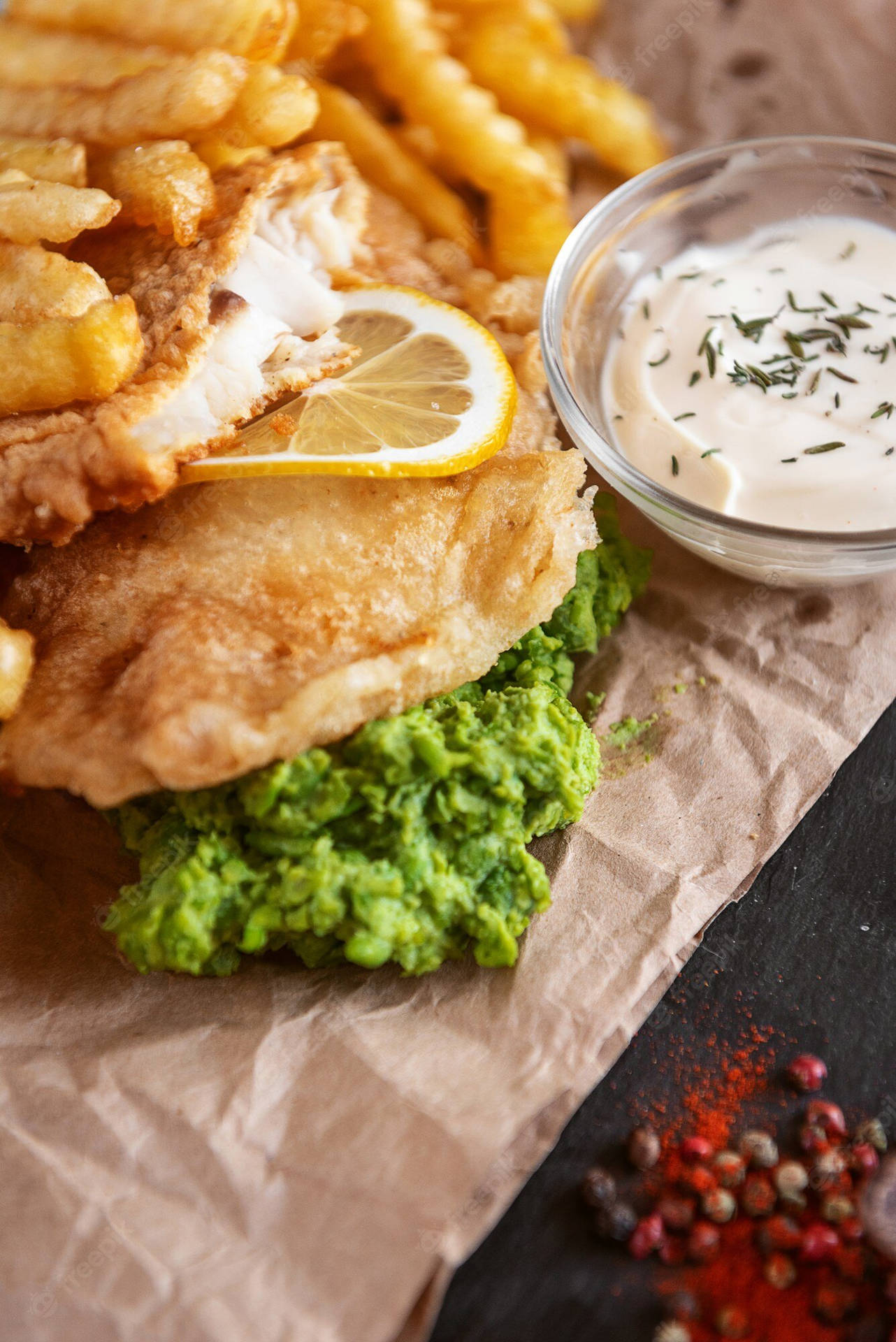 Fish And Chips On A Brown Paper Sheet