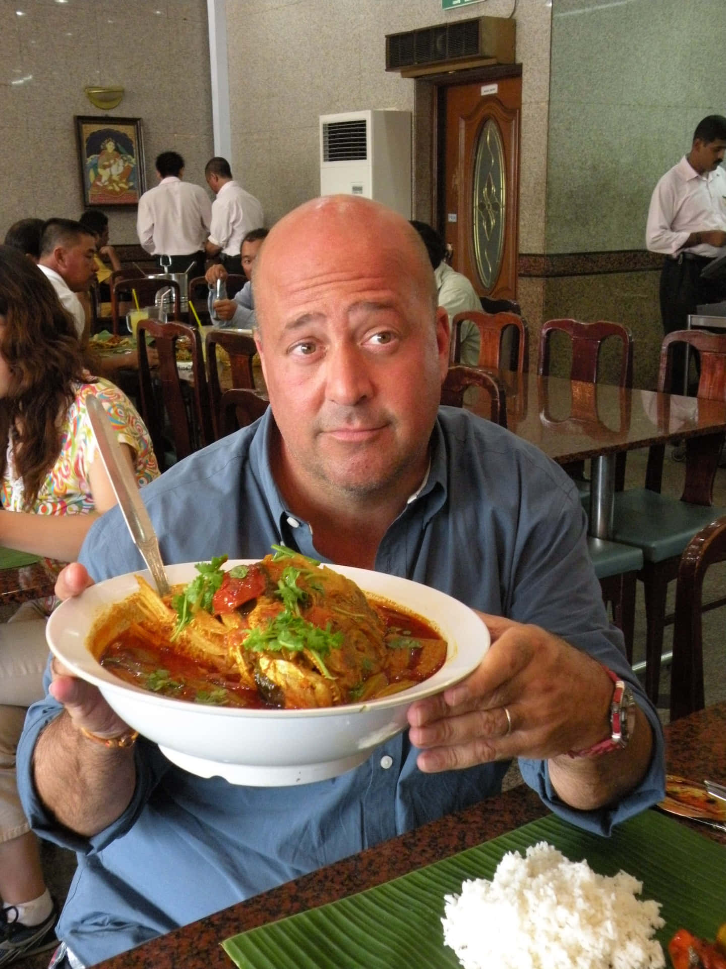 Fish Head Curry Singaporean Signature Dish Held By A Man Background