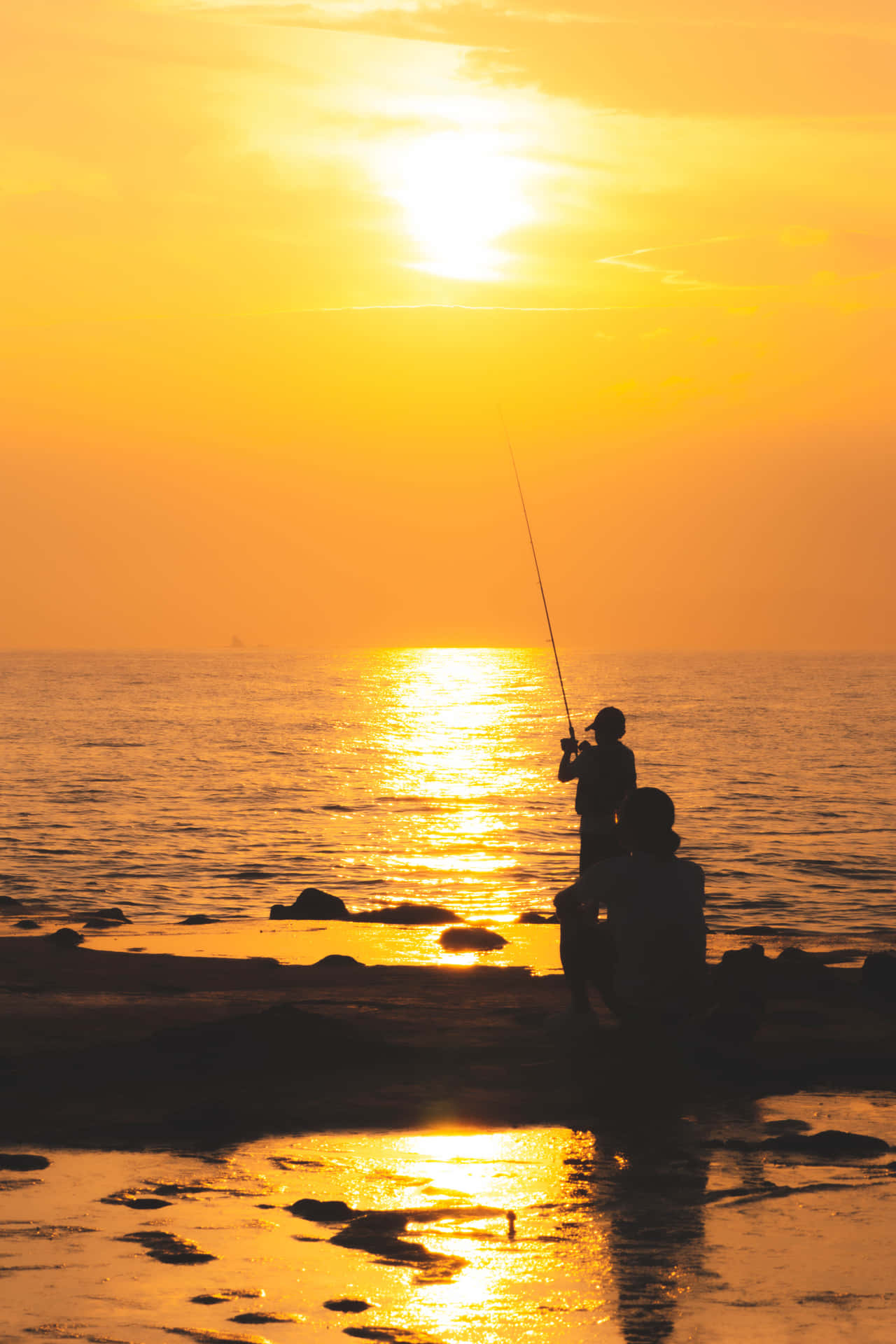 Fish On The Line, With A Smartphone In Hand.