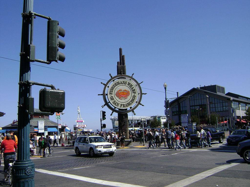 Fishermans Wharf Sign And Street Intersection Background