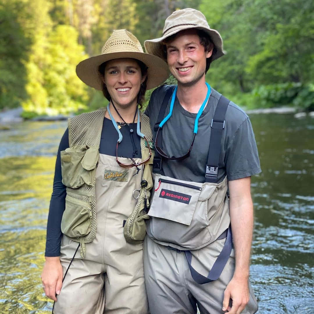 Fishing Adventure Couple Riverbank Background