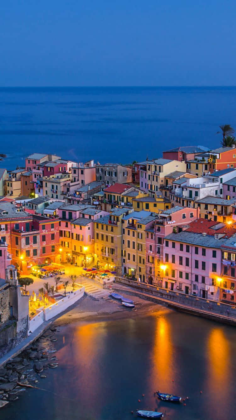 Fishing Village In Portofino Italy During Nighttime Background