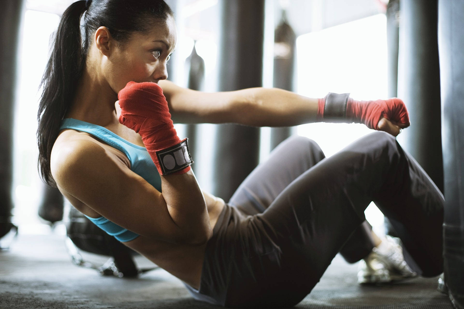 Fit Woman Executing Boxing Punches Background