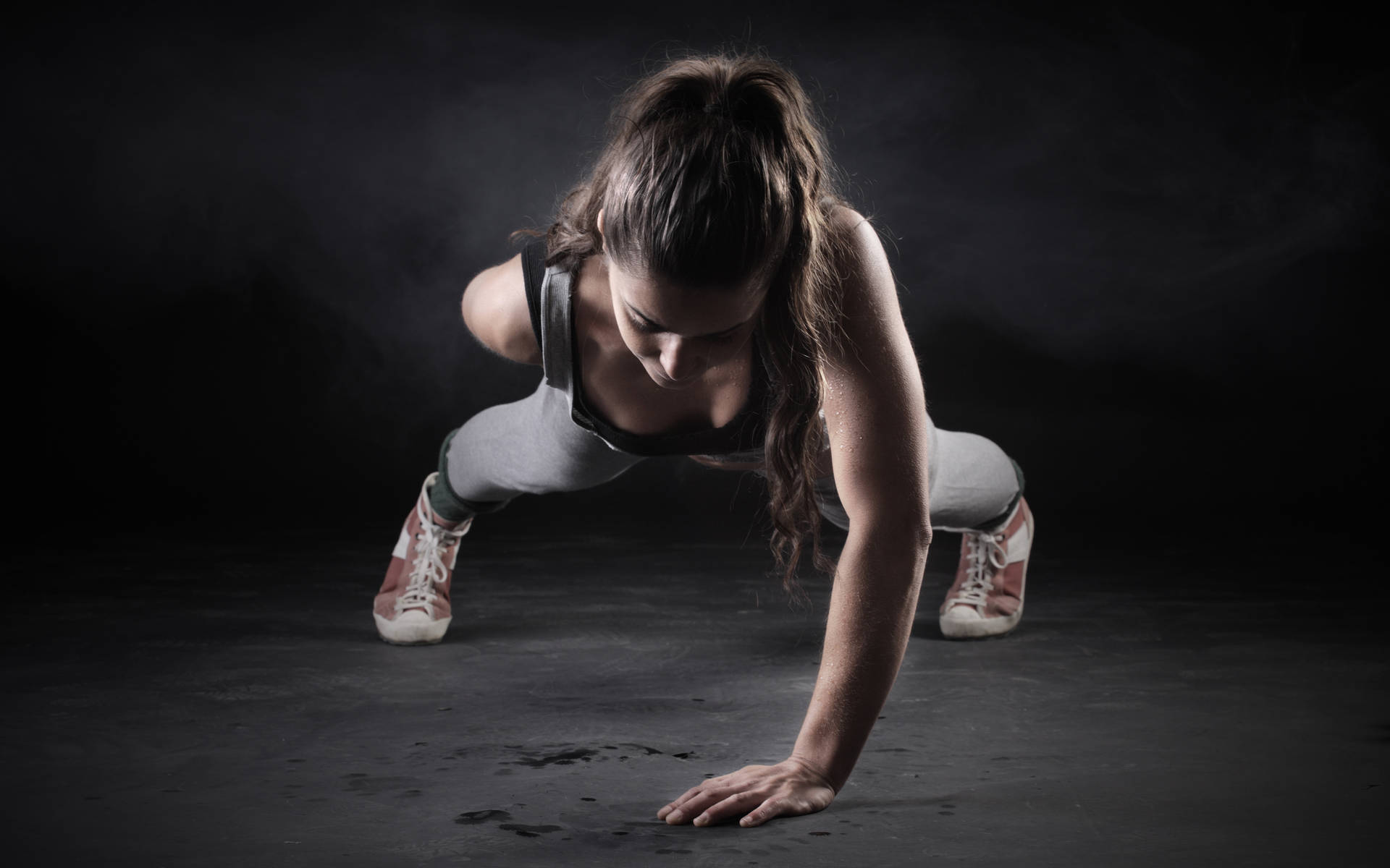 Fit Woman Performing One Handed Push-ups Background