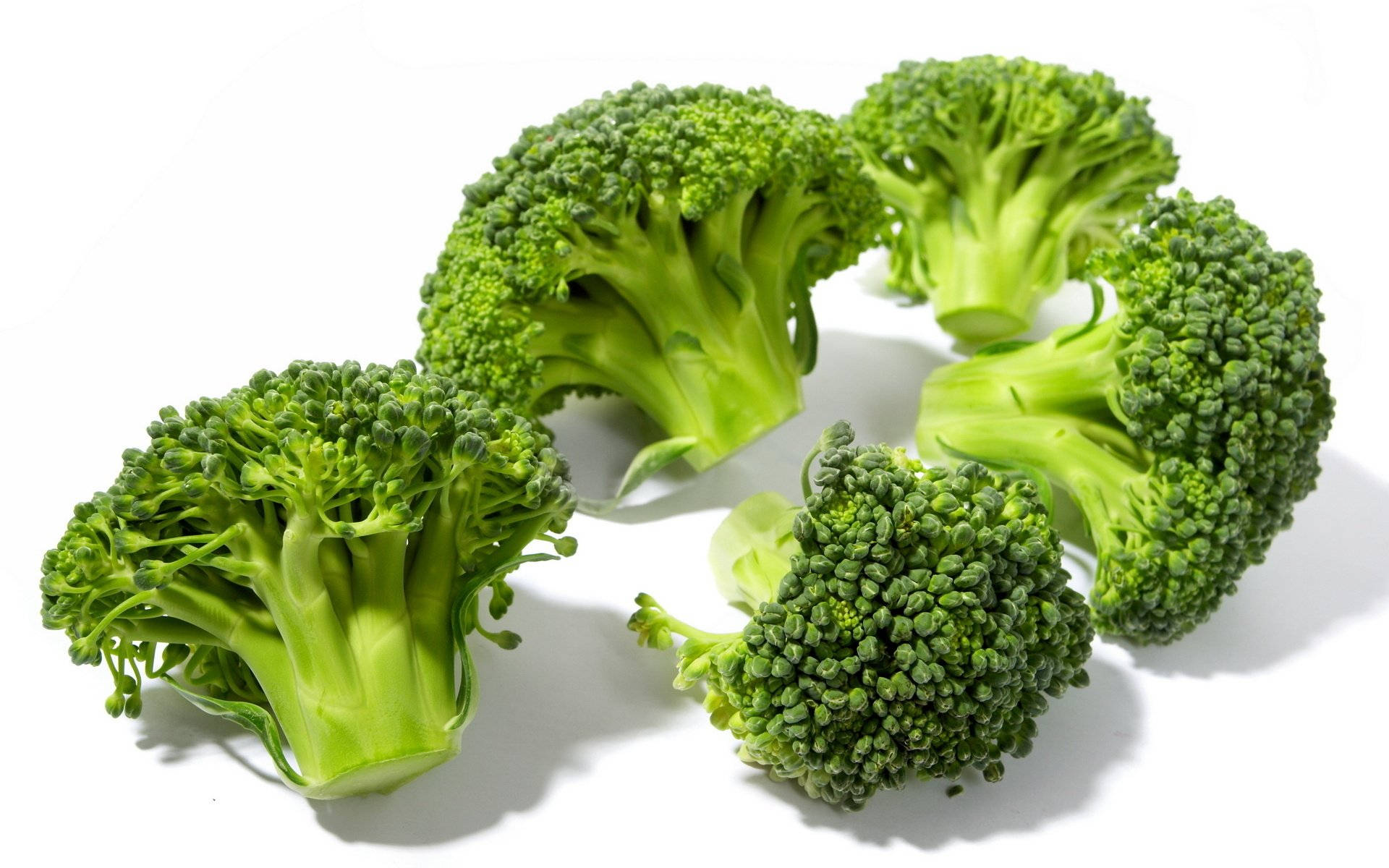 Five Green Broccoli Heads Background