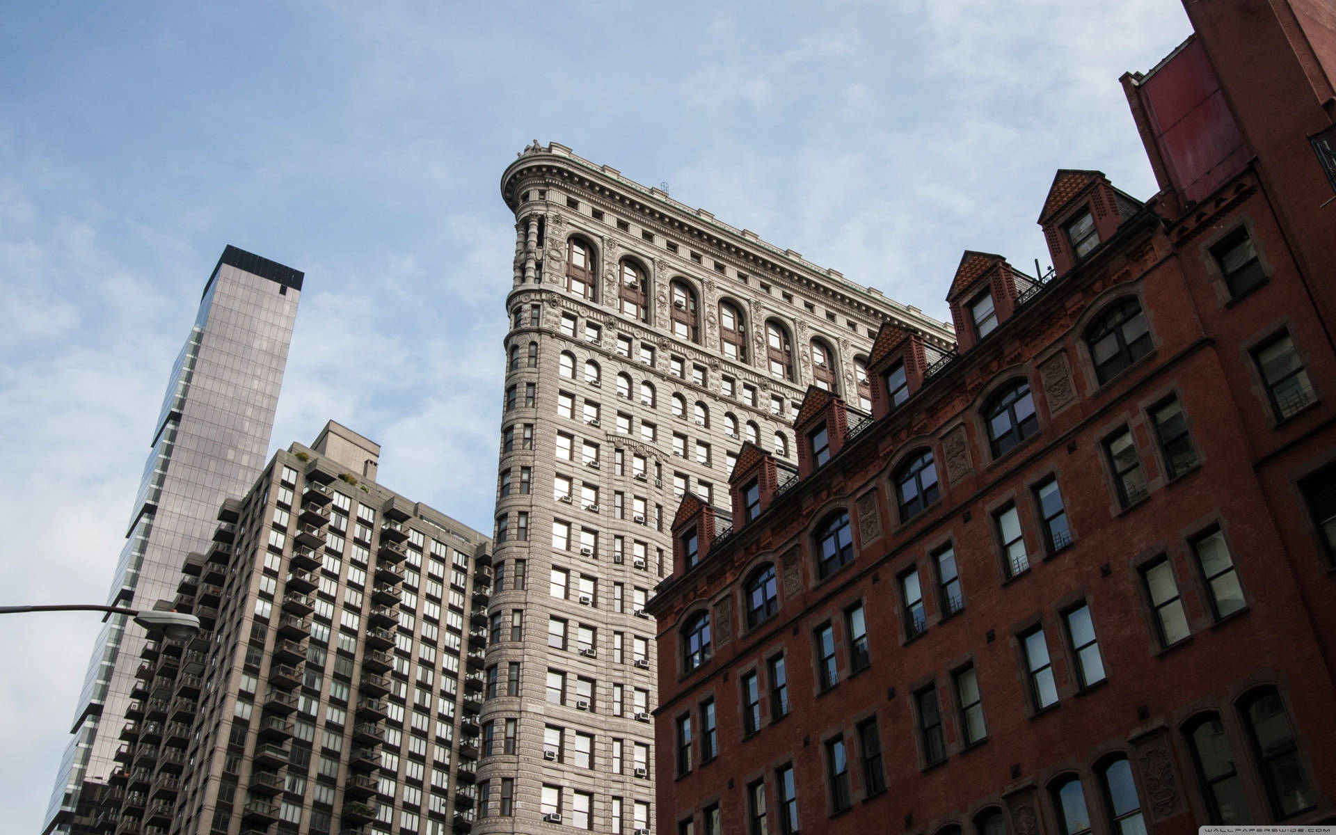 Flatiron Building Surrounded By Buildings Background