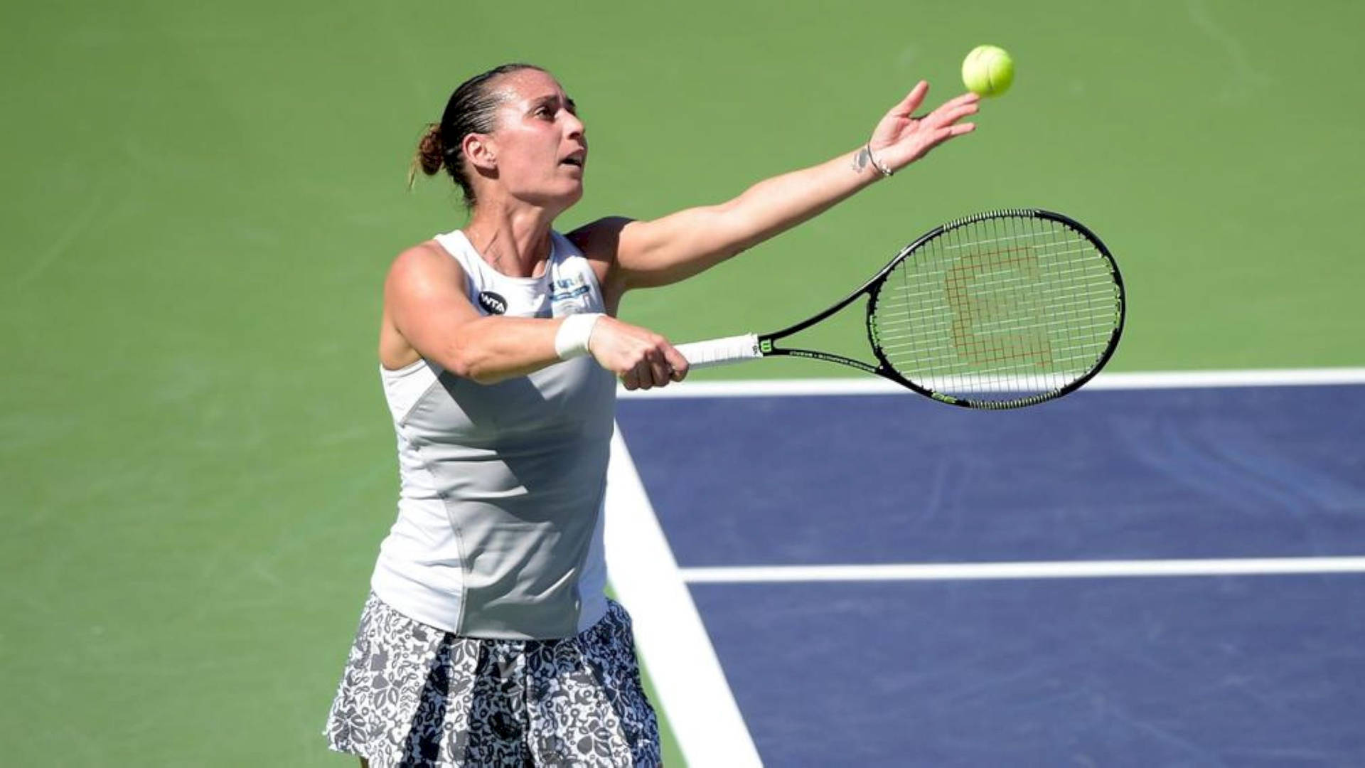 Flavia Pennetta Executing A Powerful Tennis Serve Background