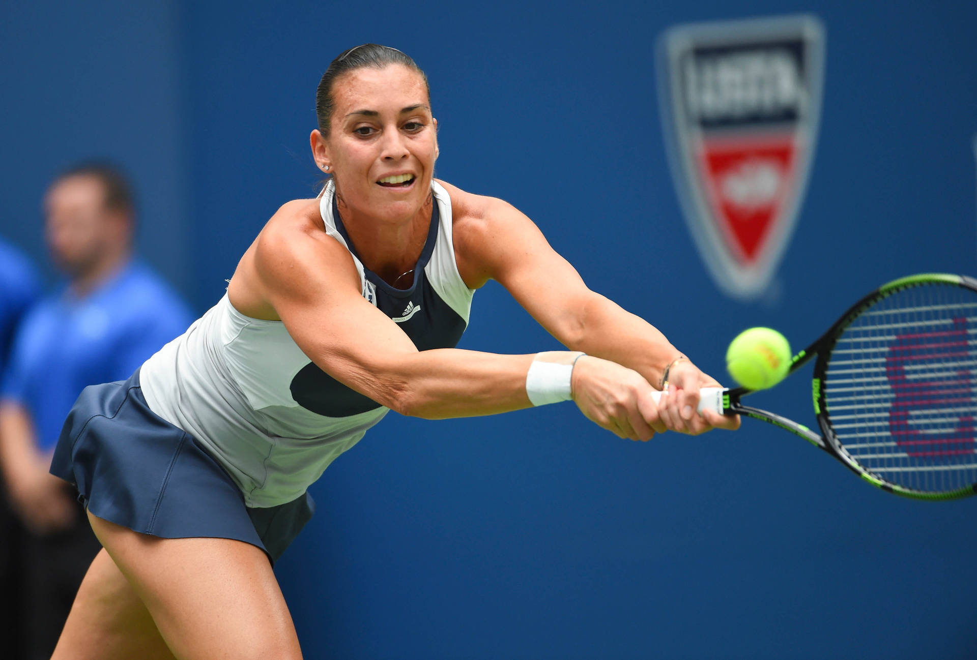 Flavia Pennetta In Action On The Tennis Court Background