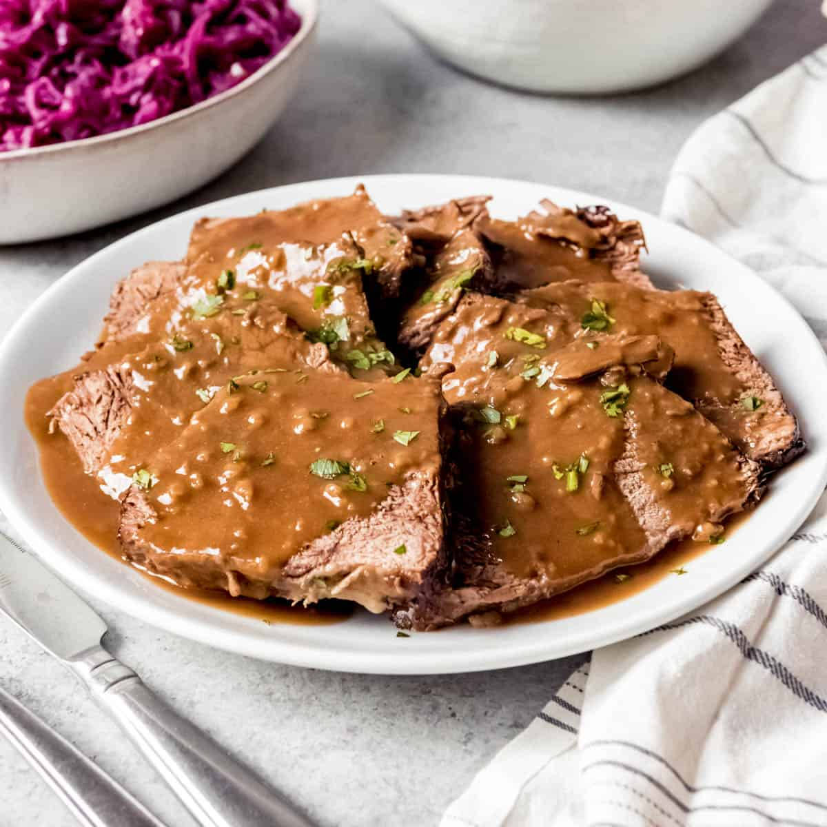 Flavorful Sauerbraten Traditional German Dish With Herbs Background