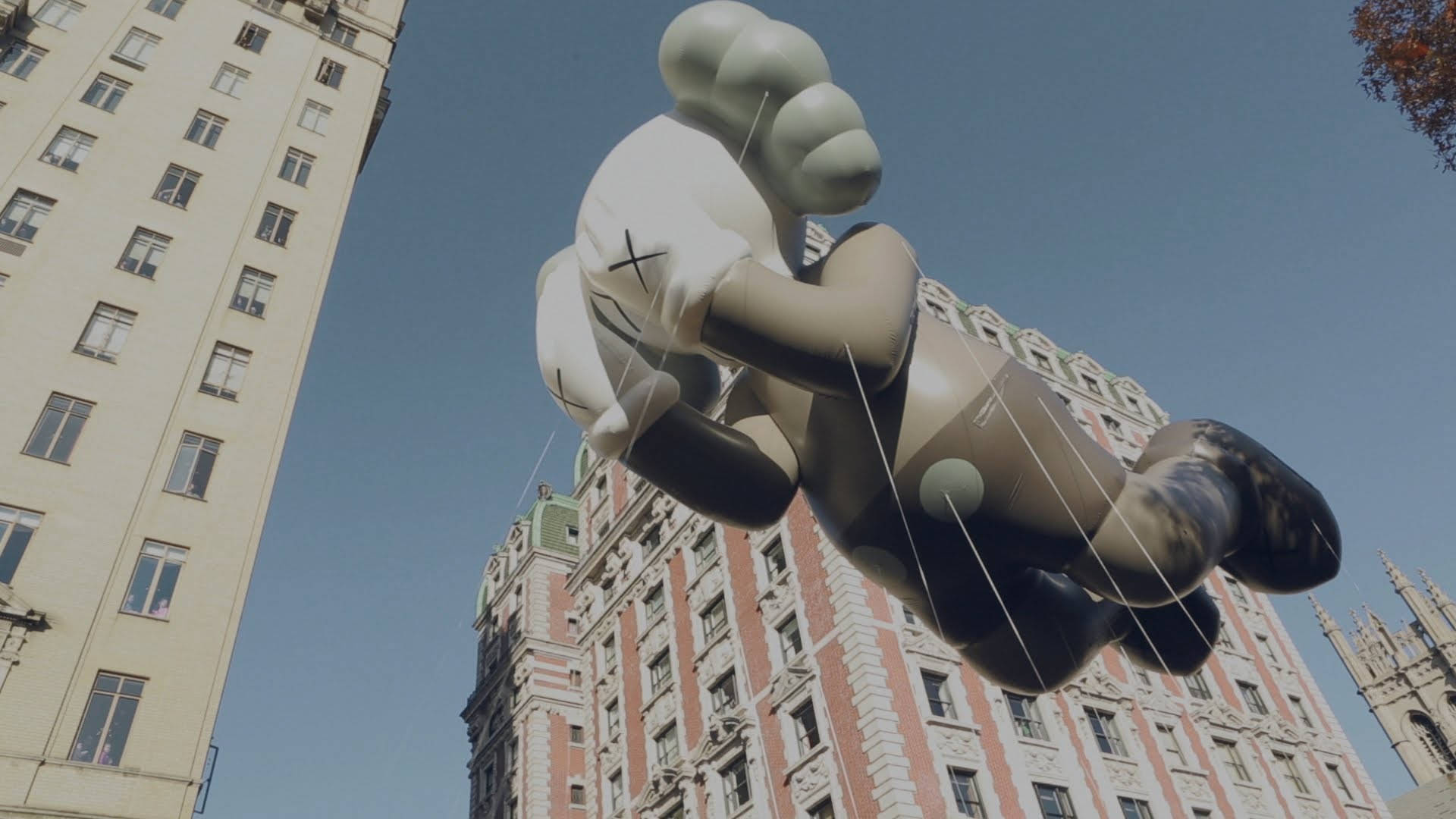 Floating Kaws Passing Through Background