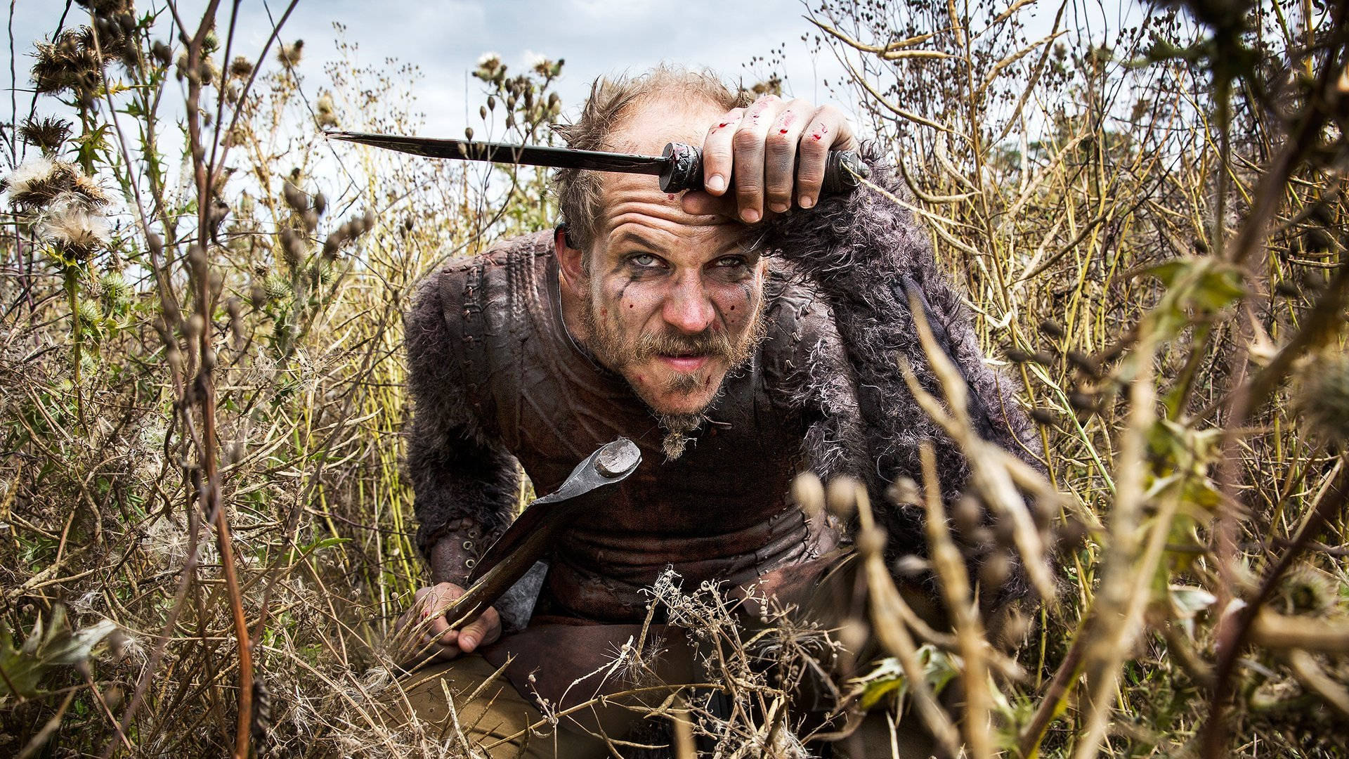 Floki From Vikings In Bushes Background
