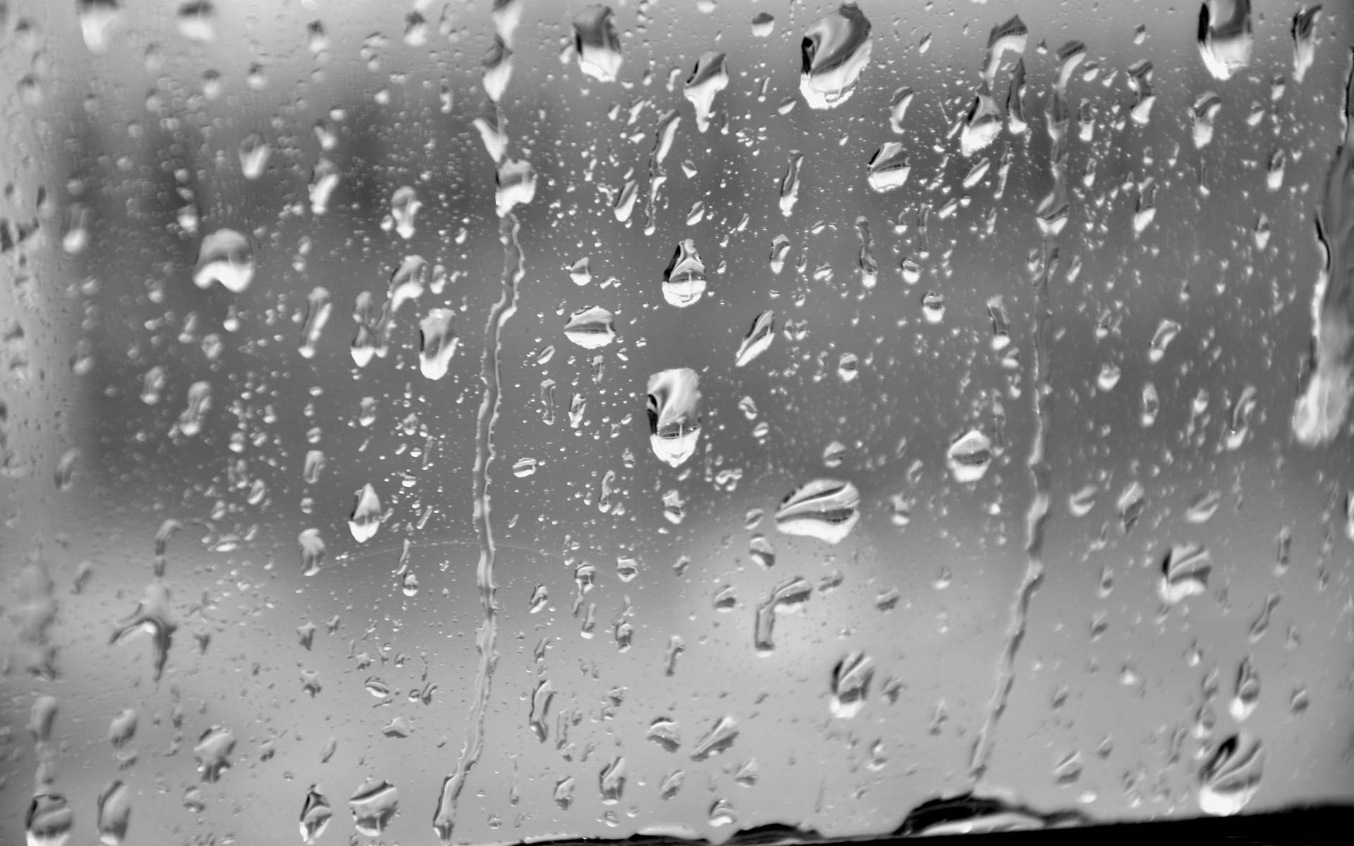 Flowing Raindrops On Glass Surface Greyscale Background