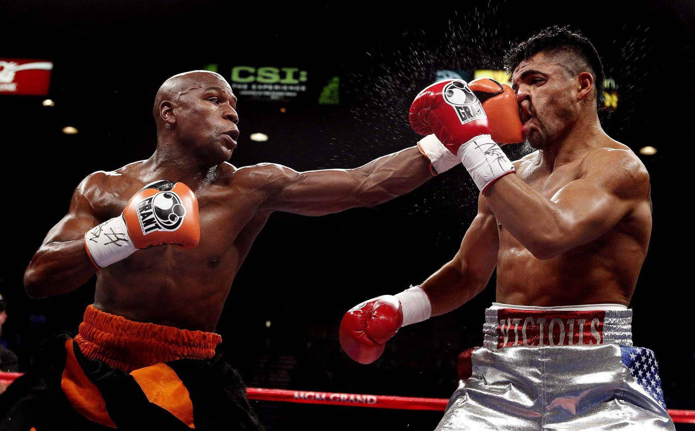 Floyd Mayweather Punching His Foe's Face Background