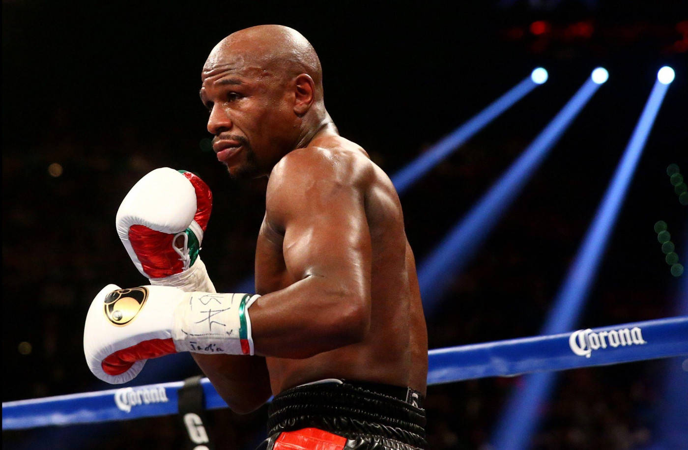 Floyd Mayweather Raising Gloves Light Shines Background