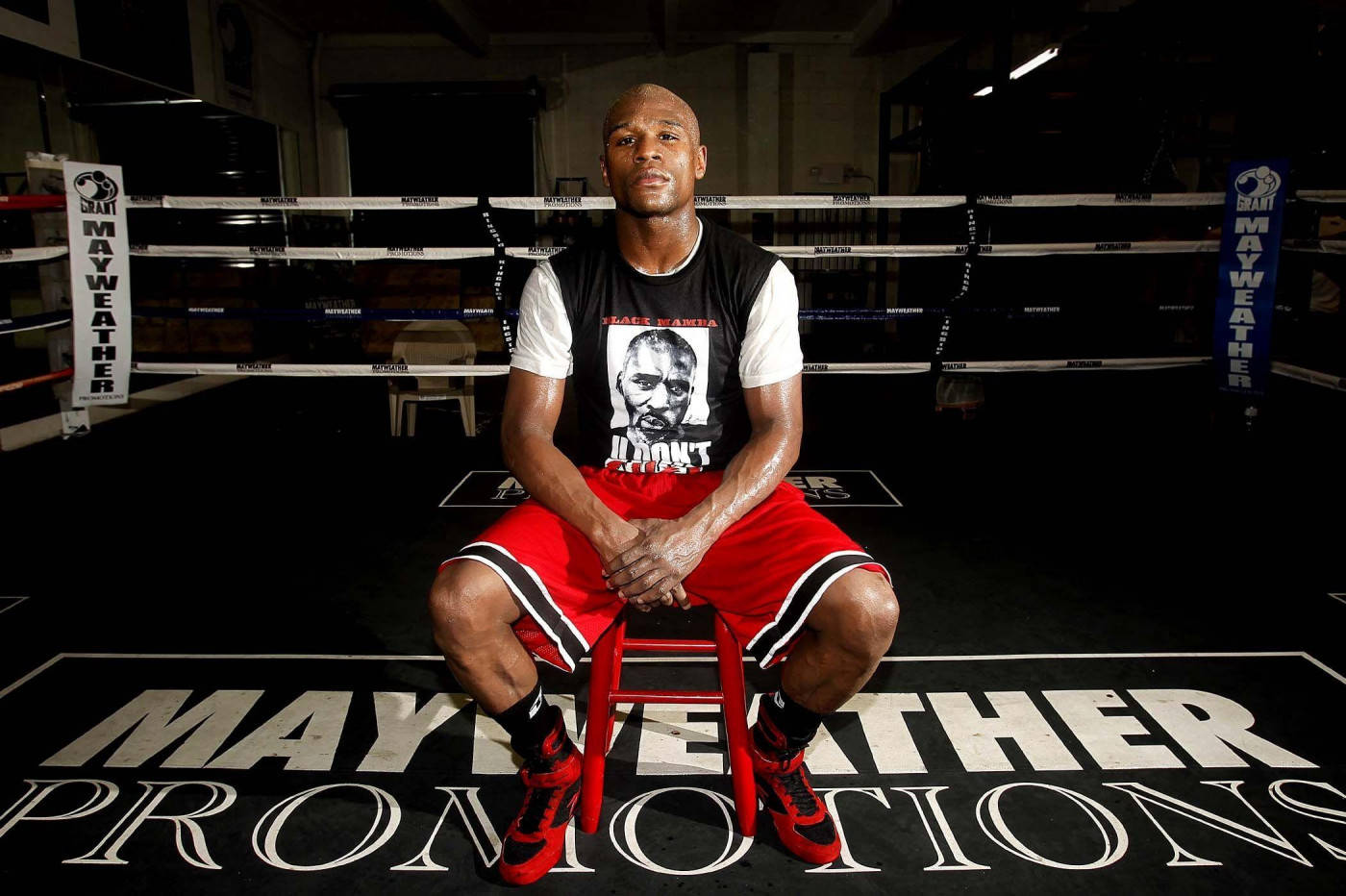 Floyd Mayweather Sitting On Red Chair Background