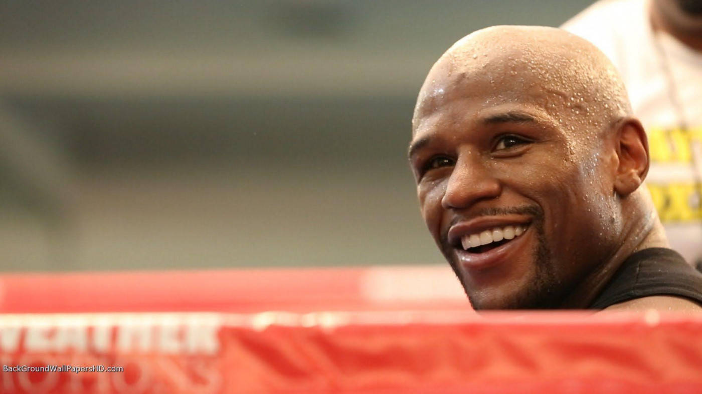 Floyd Mayweather Smiling In The Ring Background