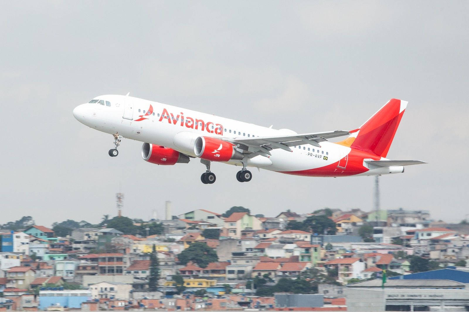 Flying Avianca Brasil Airline Airbus Over Houses