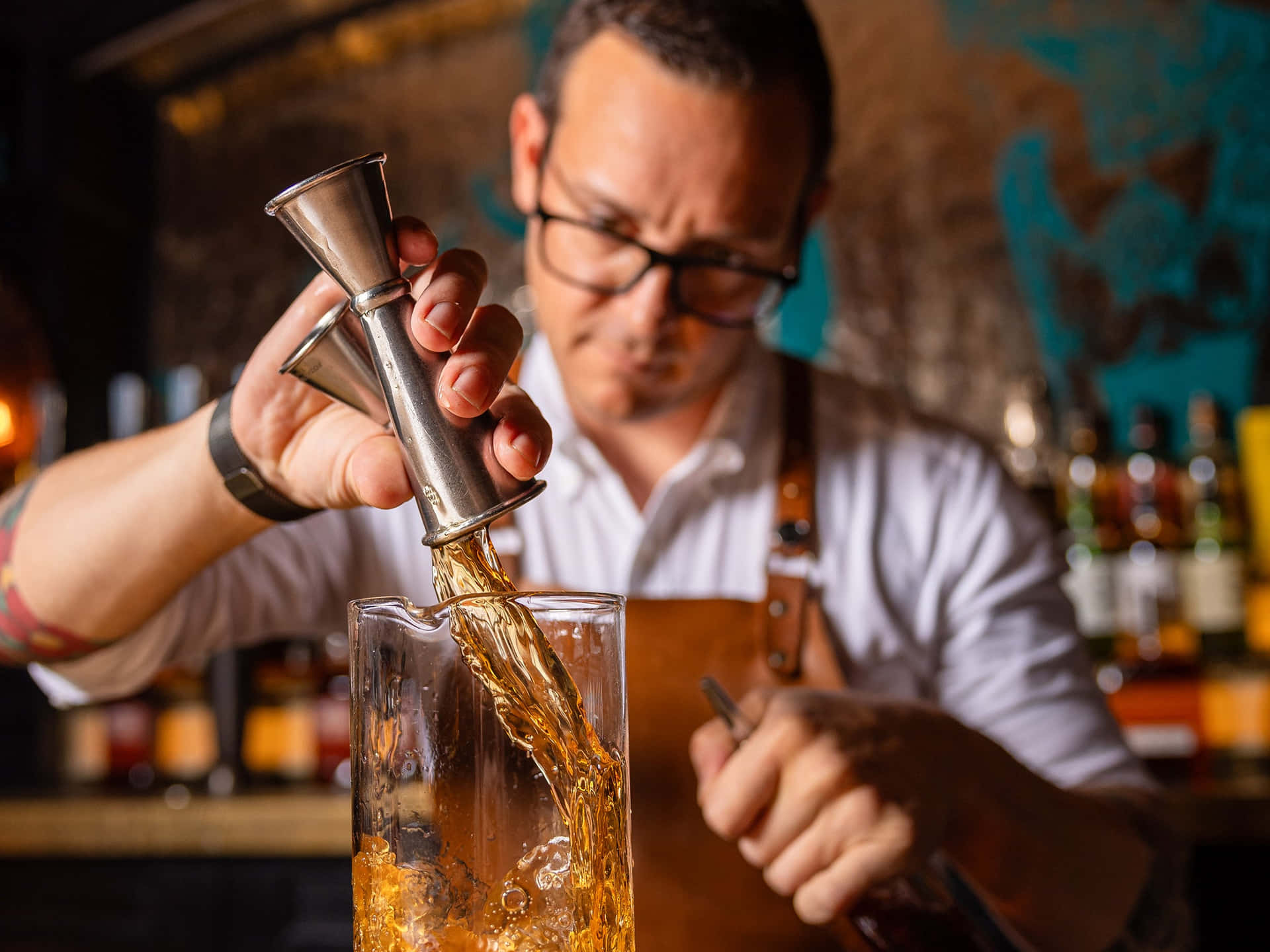 Focused Bartender Pouring Drink Background