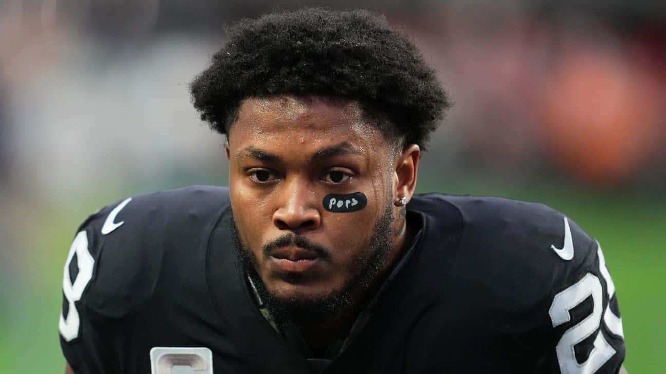 Focused Football Player Josh Jacobs Background