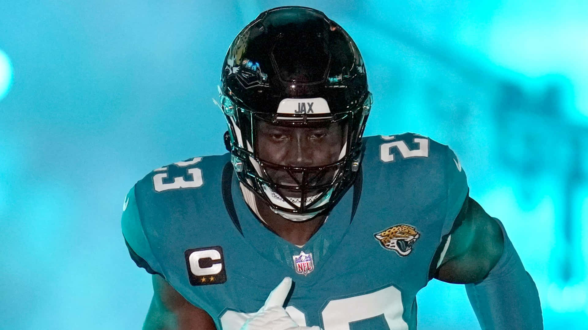 Focused Football Playerin Action Background