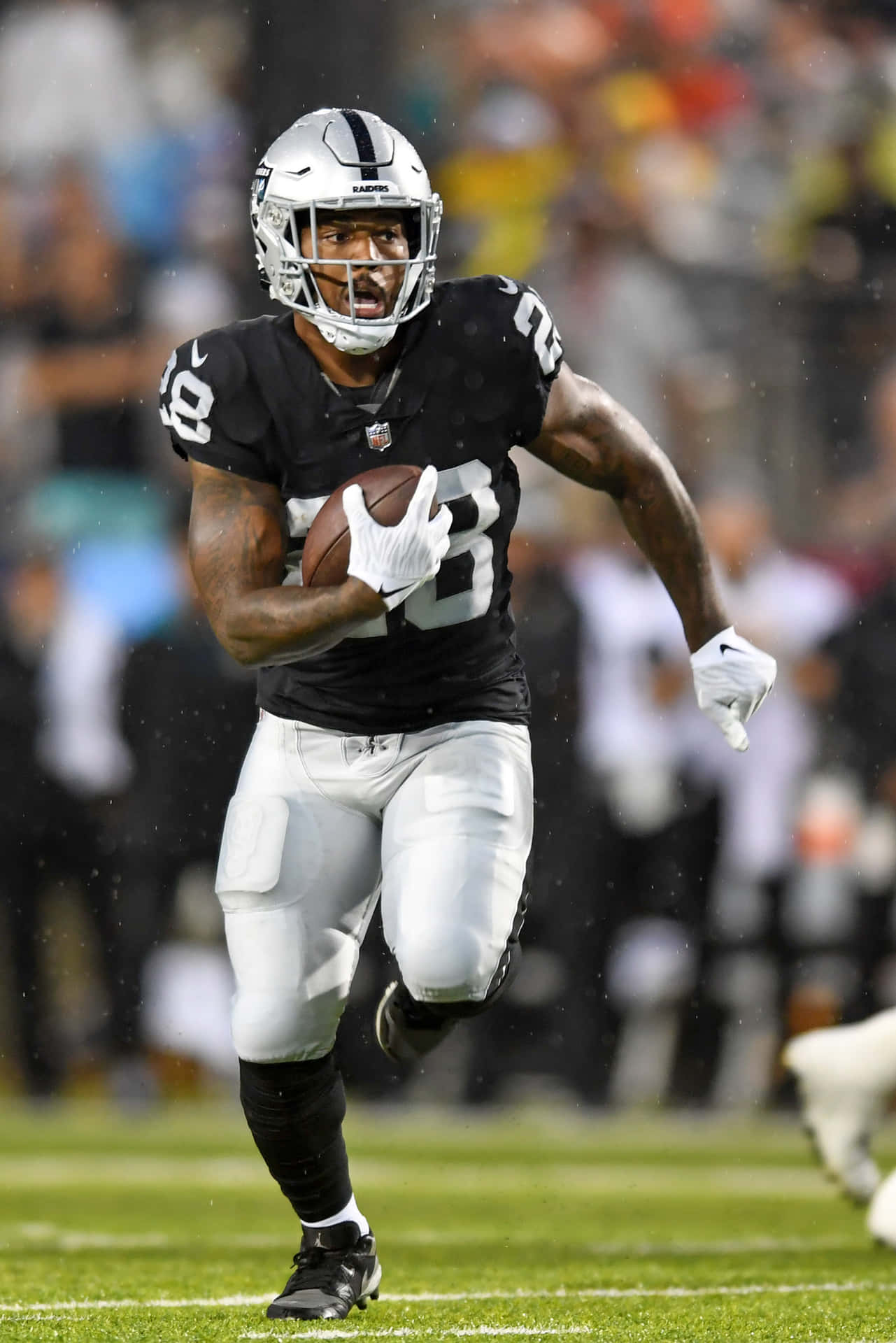 Focused Football Playerin Action Background