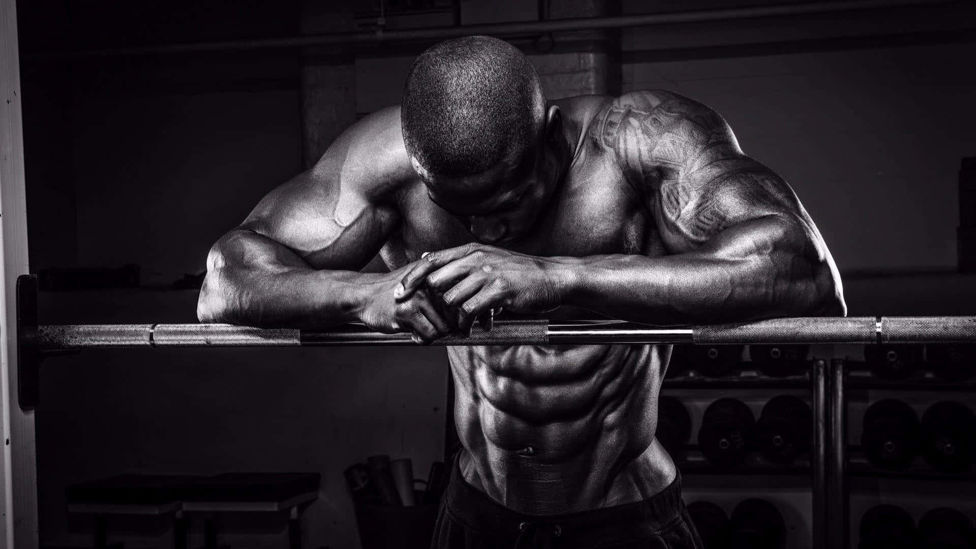 Focused Muscular Man Resting During Workout Background