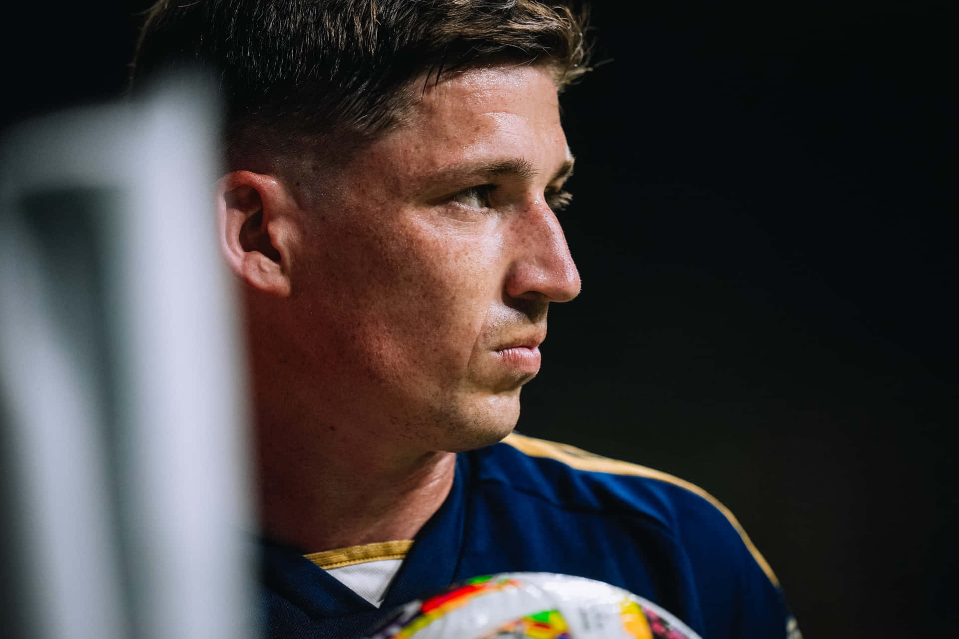 Focused Soccer Player Profile Background