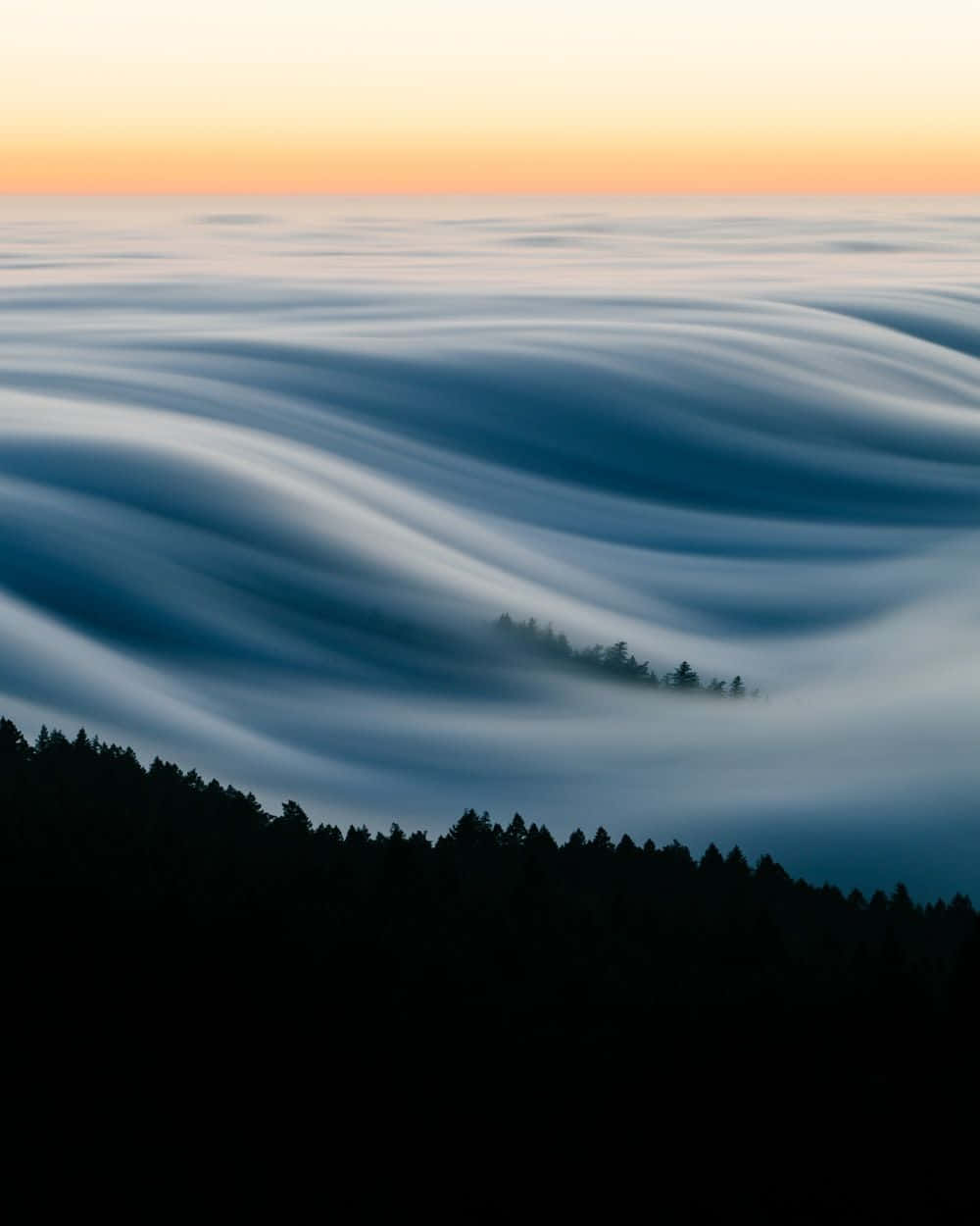 Fog Over A Mountain Range At Sunrise