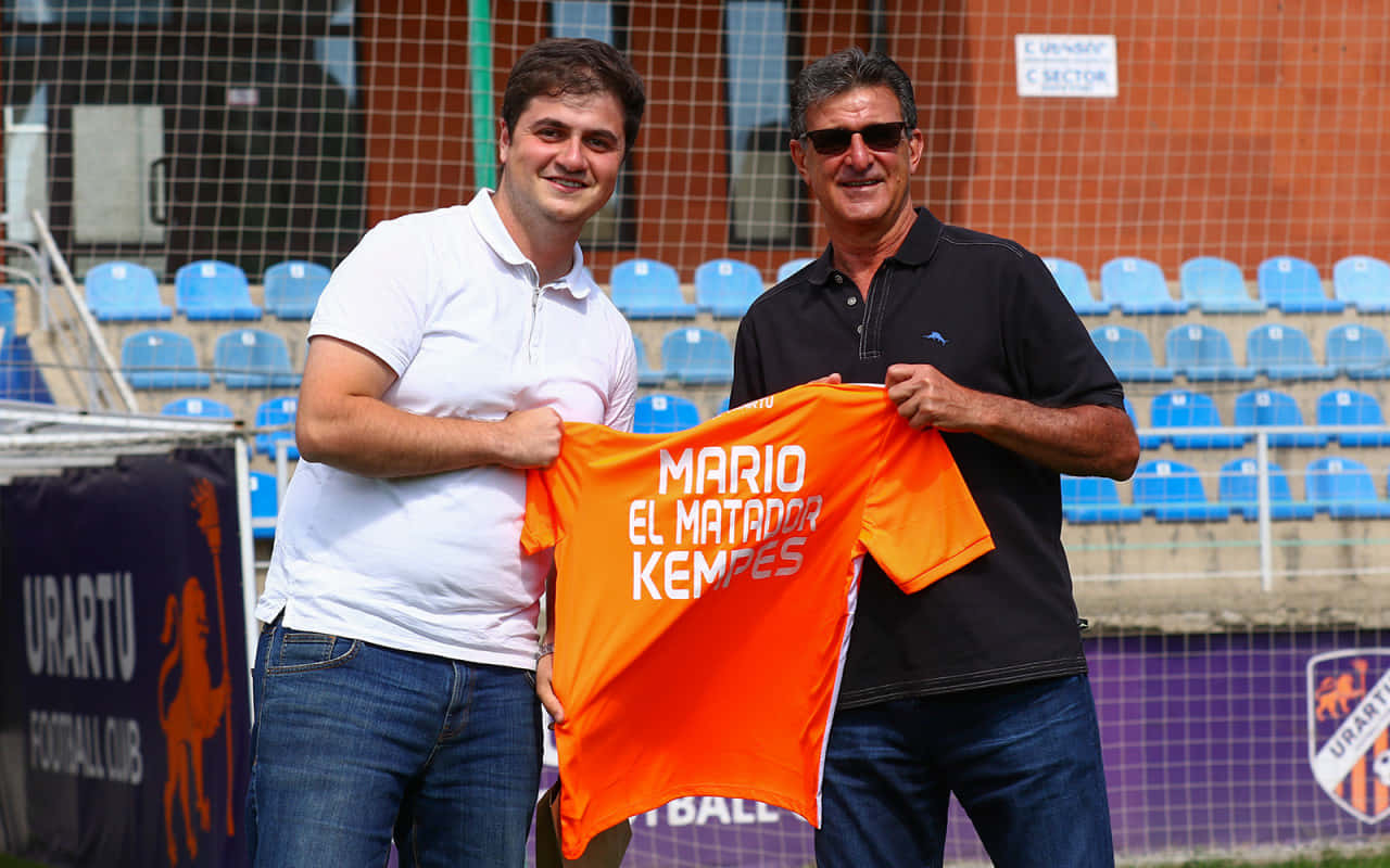 Football Athlete Mario Kempes Orange Shirt Background