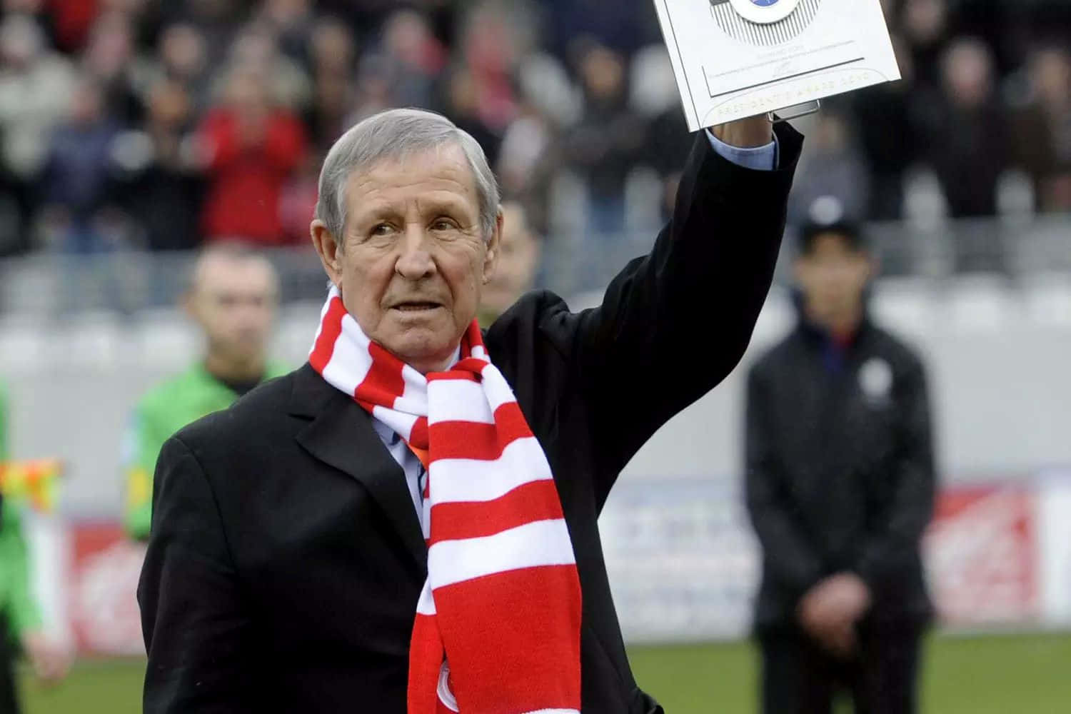 Football Legend Saluting Crowd Background