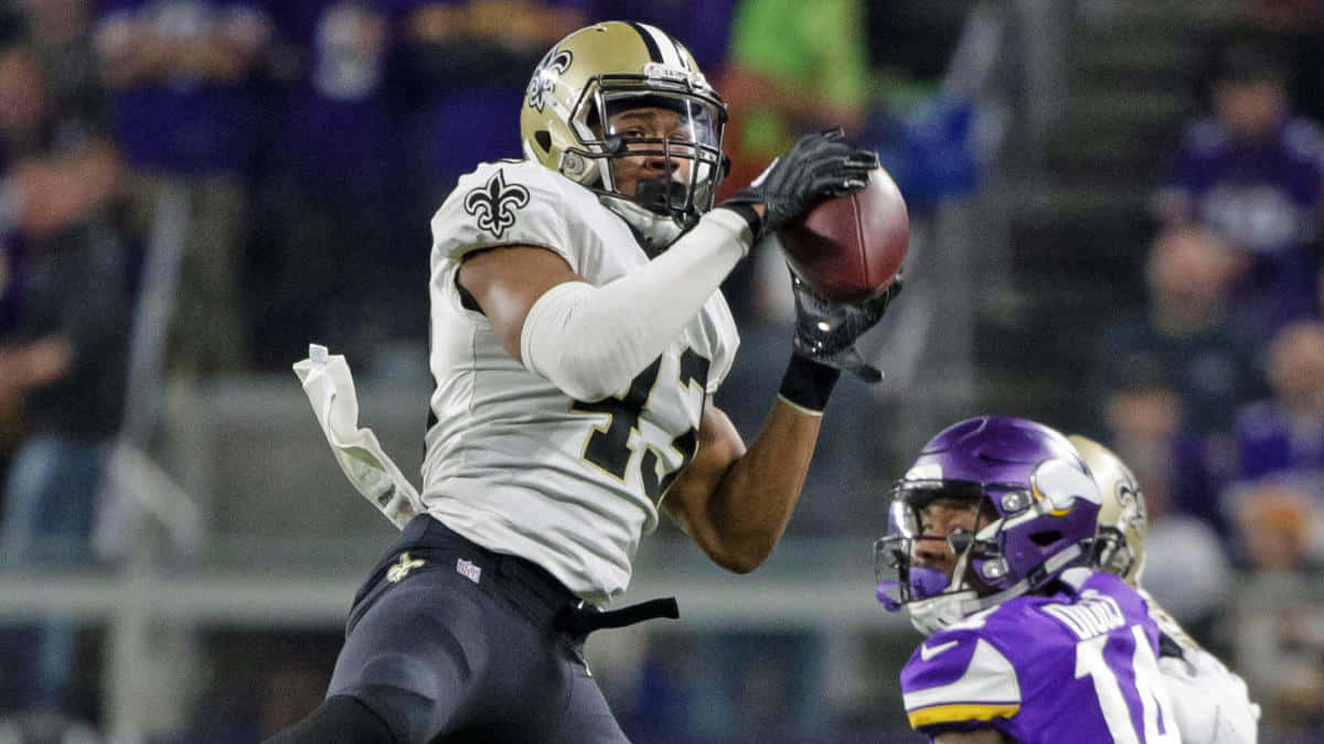 Football Player Catching Ball During Game Background