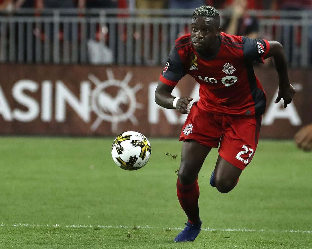 Football Player Chris Mavinga Chasing Ball Background