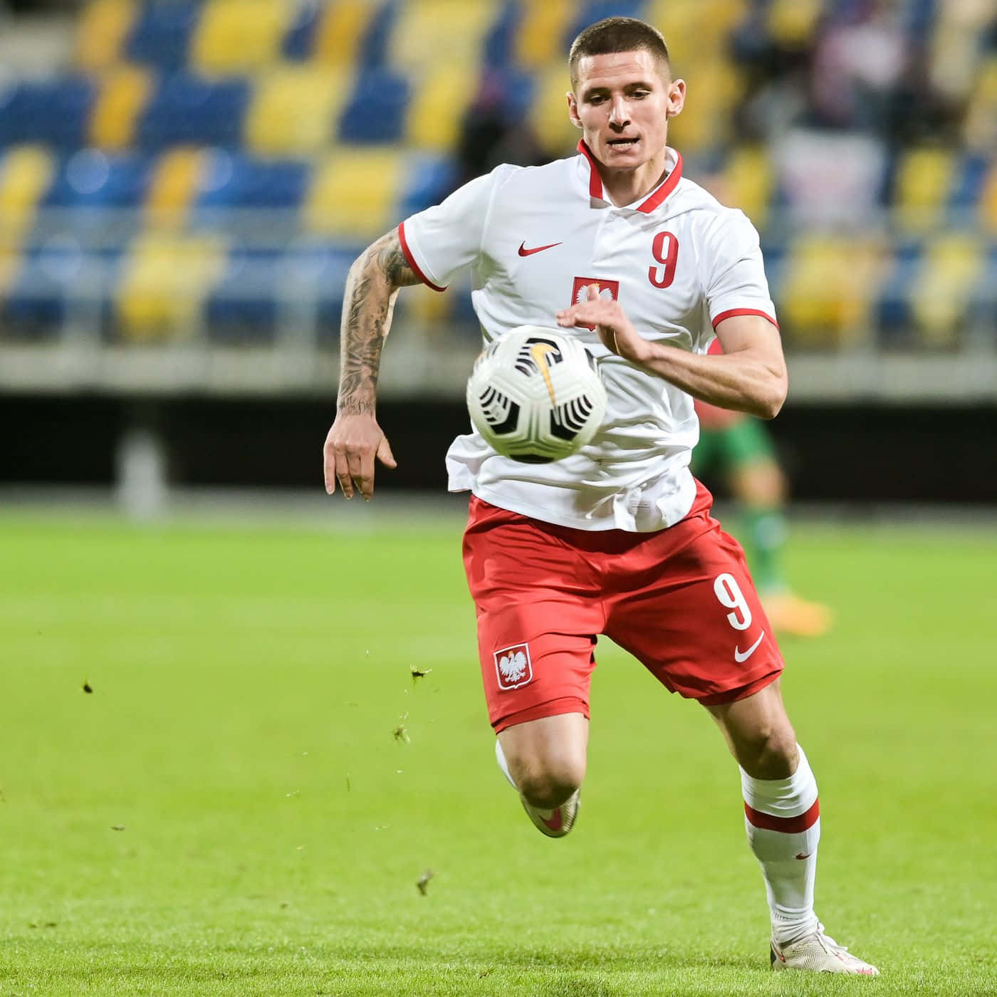 Football Player Patryk Klimala Running Background