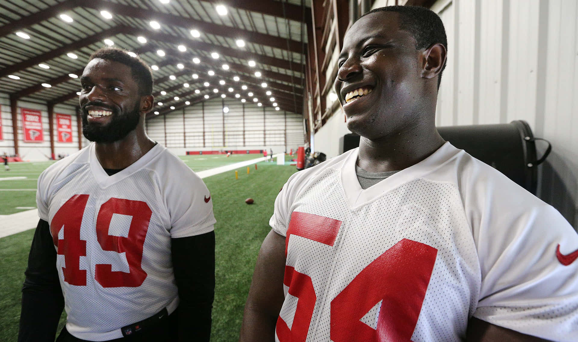 Football Players Laughing Indoors43and54 Background