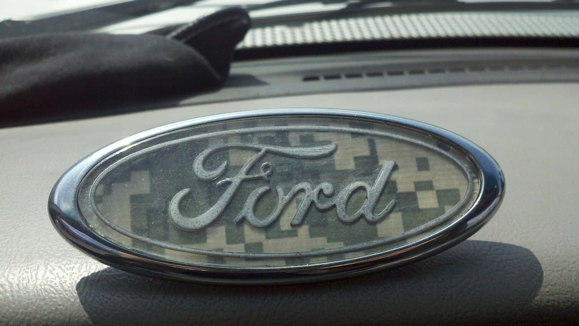 Ford Logo Shining Bright On A Black Background Background